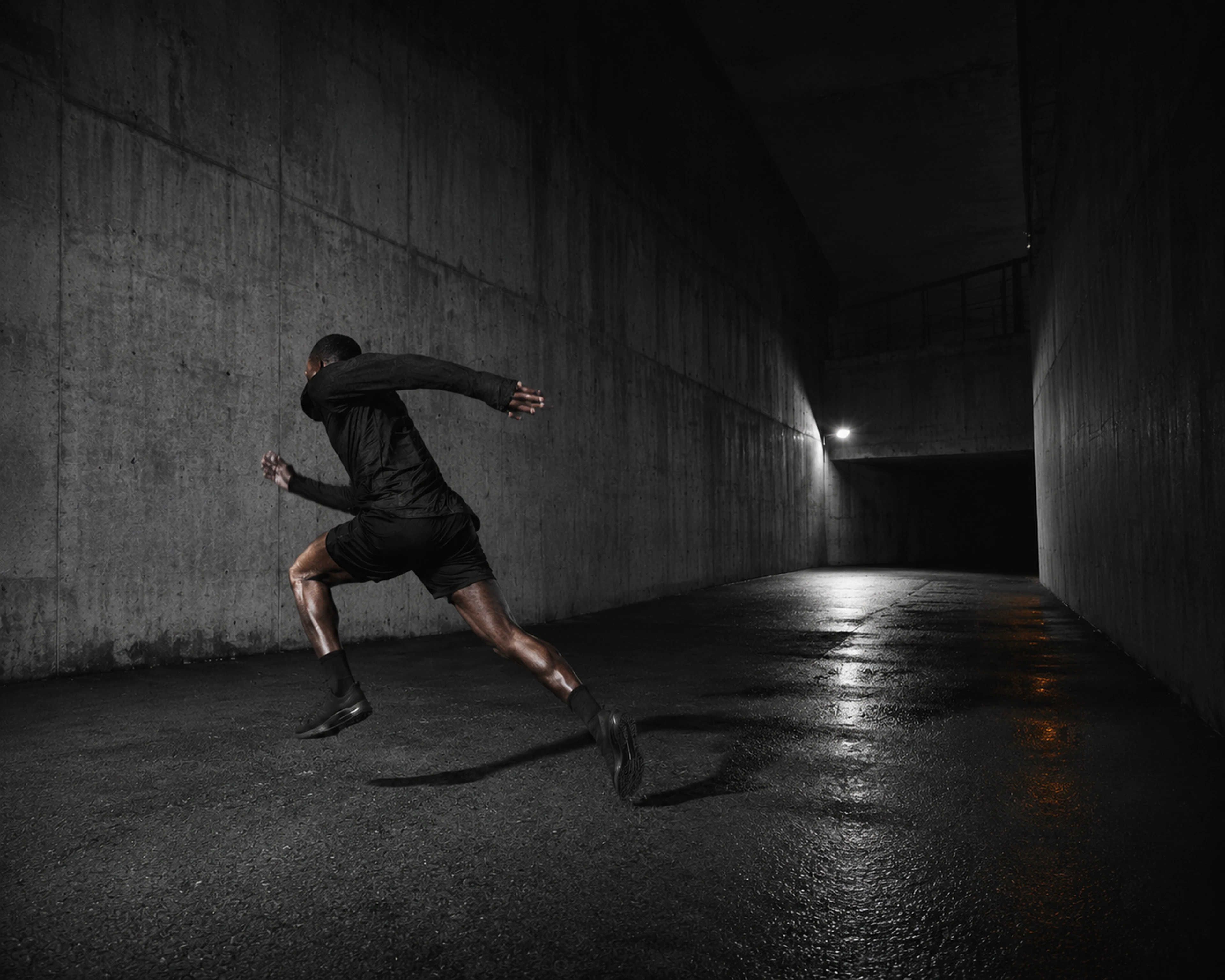 Athlete moving through concrete architecture at night